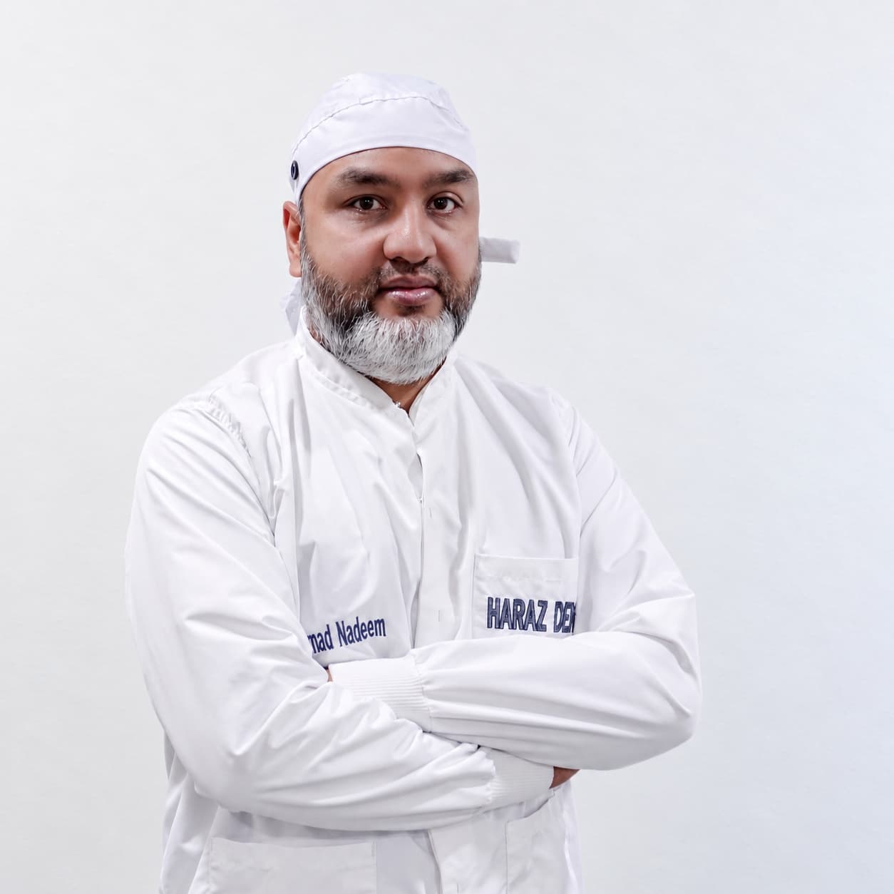 Dr. Nadeem of Haraz Dental Group in a white clinic coat